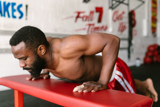 Man performing push-ups as part of 7 exercises to build muscle