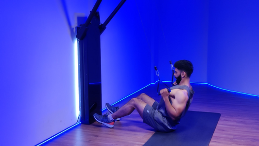 Man performing a Grounded Lat Pulldown exercise on a bench in a gym.