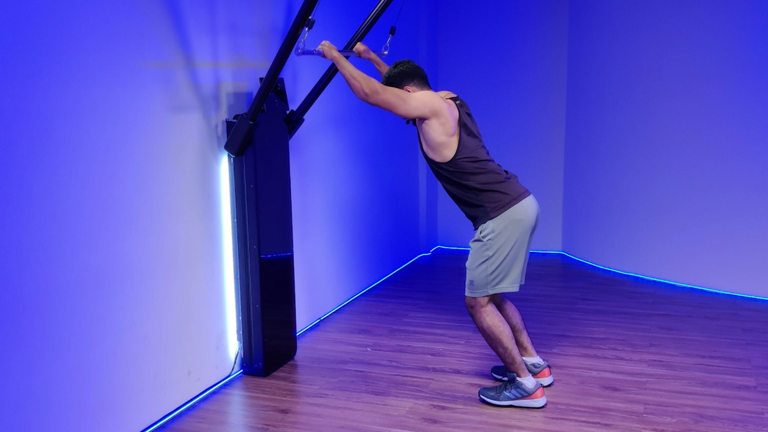 Man performing a Barbell Lat Pulldown exercise in a gym