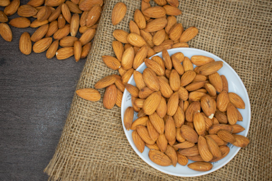 A plate of almonds on a burlap background for muscle growth