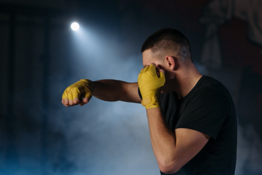 Man training with yellow gloves, emphasizing testosterone and muscle gain