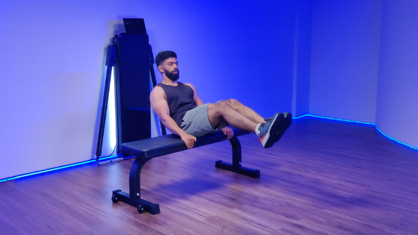 Man performing a sit-up exercise on a bench for six-pack abs at home workout.